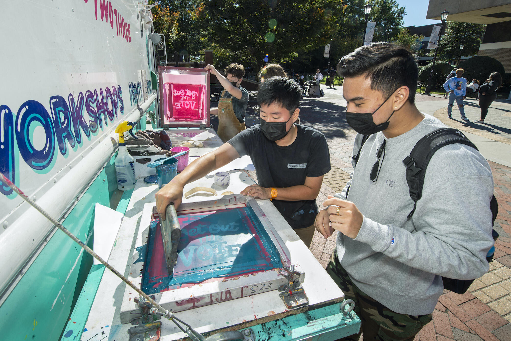 Students screen print tote bags at a VCU Votes event on Oct. 27.