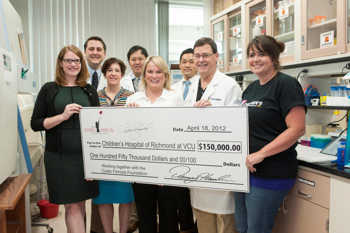 Mary Lou Hamlin, mother of no. 11 Denny Hamlin, visited the CHoR cystic fibrosis lab team to learn more about how the donation has contributed to new CF research and treatment discoveries over the past three years. (From left to right: Jenny Brady, lab manager; Terri Quinan, Cystic Fibrosis Foundation; Mary Lou Hamlin; Bruce Rubin, M.D., professor and chair, VCU Department of Pediatrics and physician-in-chief of CHoR; Melissa Yopp, administrative director of research for CHoR; Mike Davis, lab researcher; Jonathan Ma, M.D., pediatric resident; Shuichi Kawano, M.D., physician scientist.) Photo courtesy of University Marketing.
