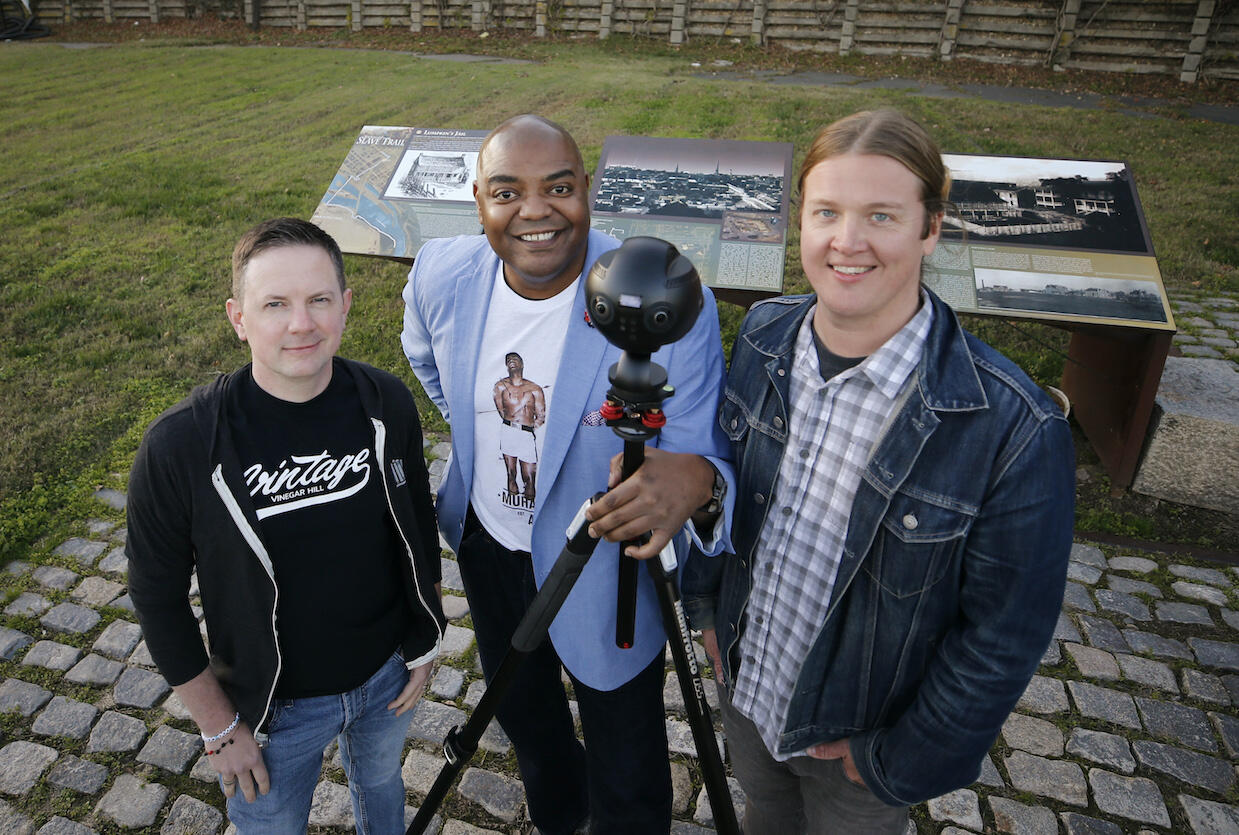 Hidden In Plain Site founders Dean Browell, Dontrese Brown and David Waltenbaugh standing in an empty field