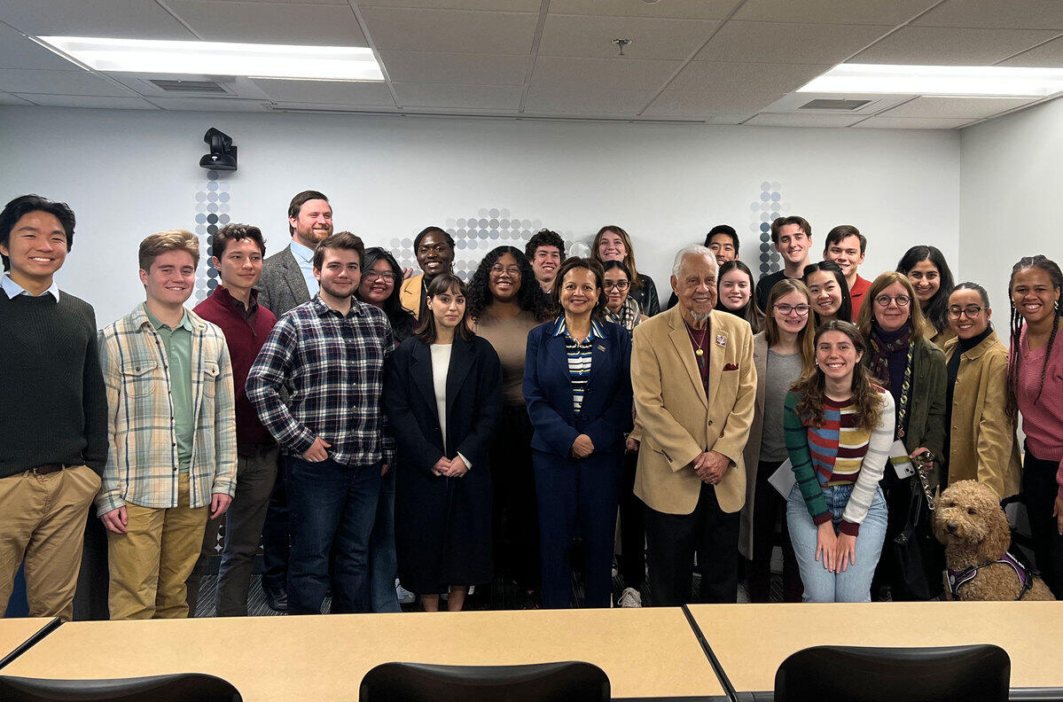 A group photo of 25 people in a classroom. 