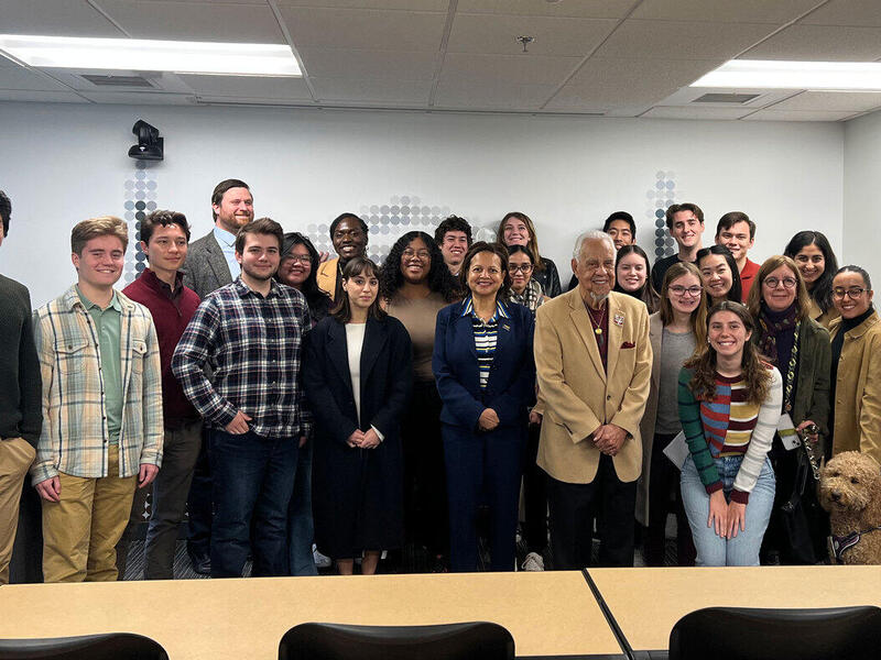 A group photo of 25 people in a classroom. 