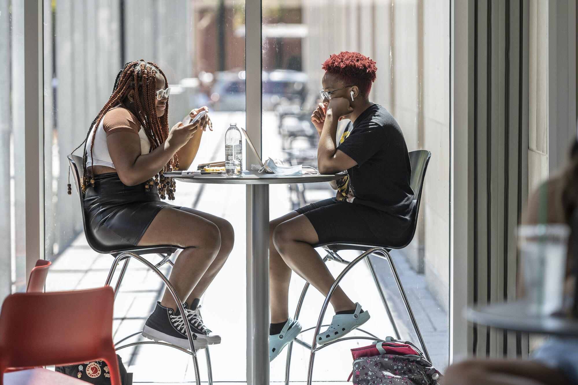 Zakira Debraux, left, and Gloria Kikwebati enjoy a snack break inside James Branch Cabell Library.