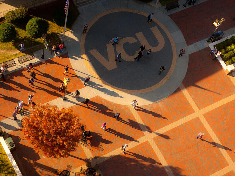 Overhead scene of campus with people walking and large letters VCU.
