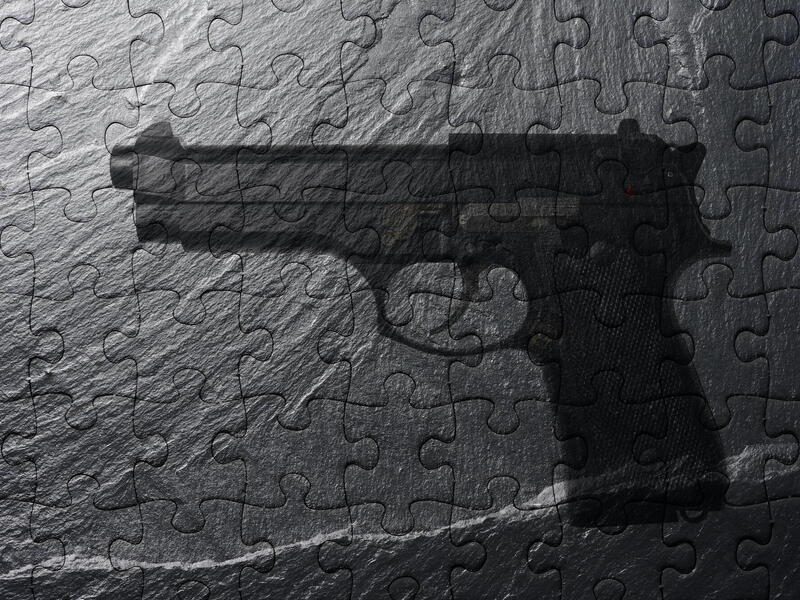 abstract image of a puzzle showing a handgun