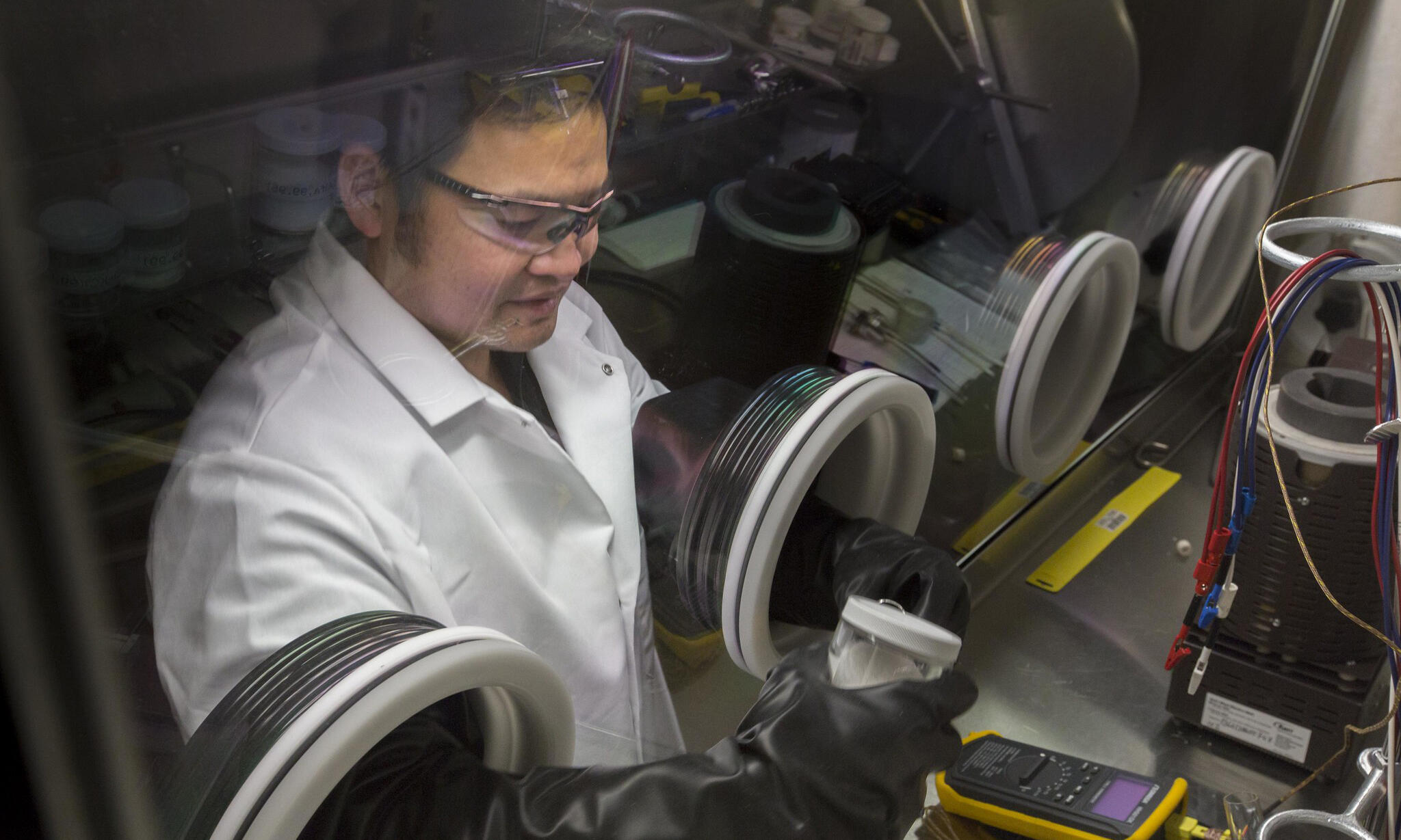 A photo of a man wearing a white lab coat