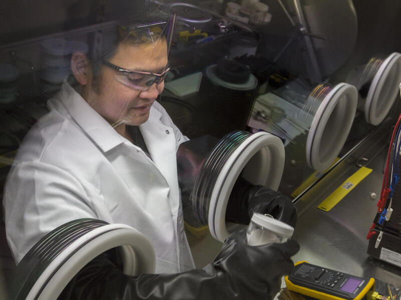 A photo of a man wearing a white lab coat