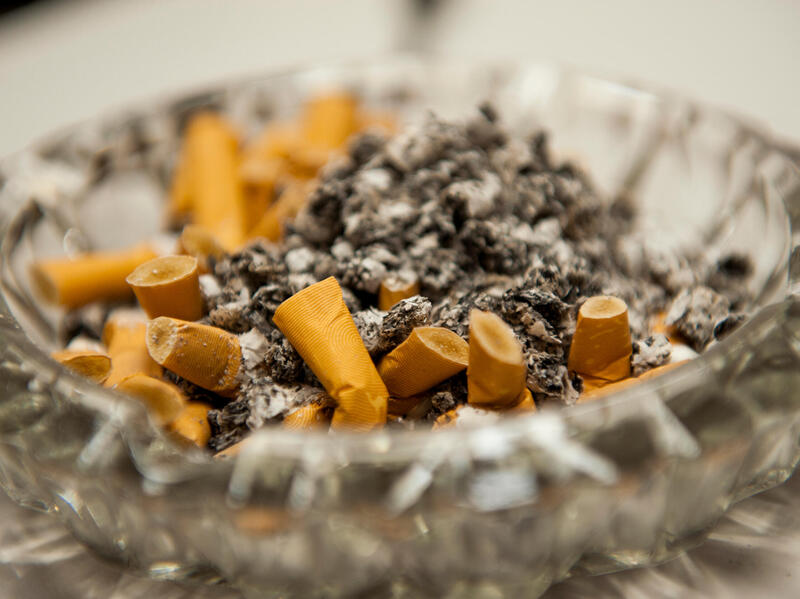 Close-up image of used cigarettes in an ashtray.