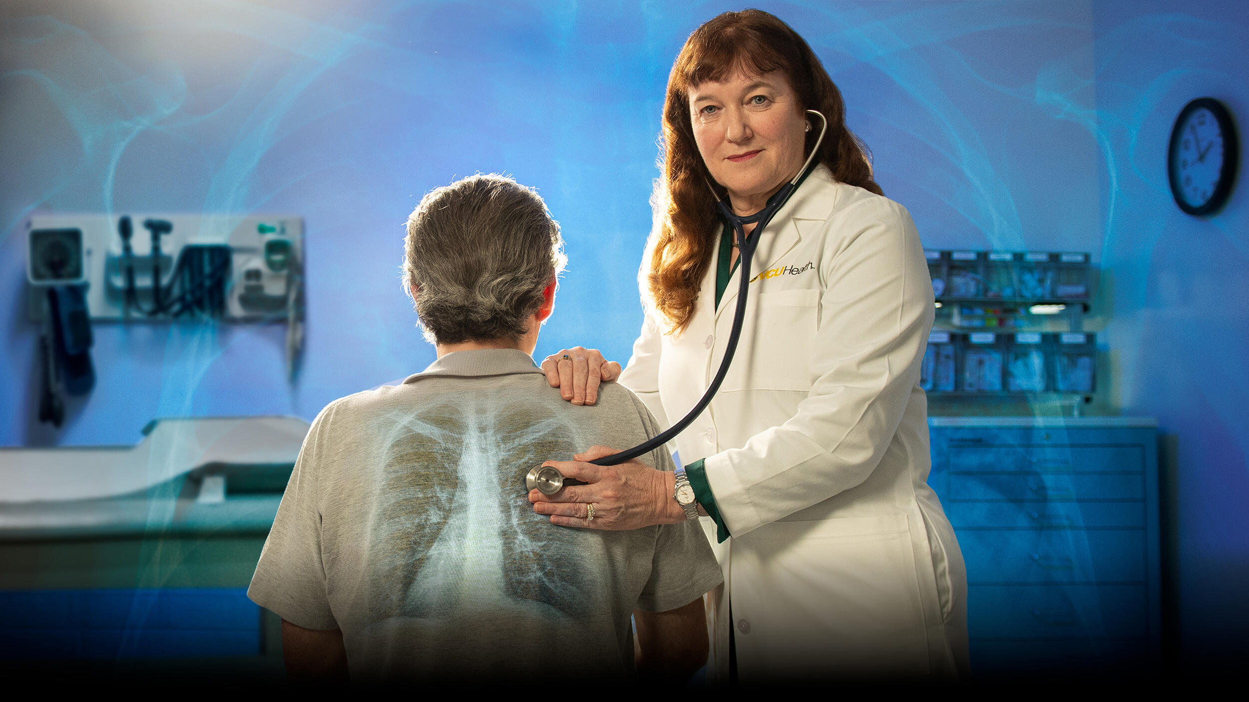 A photo of a woman using a stethoscope on a man's back in a doctor's examination room.