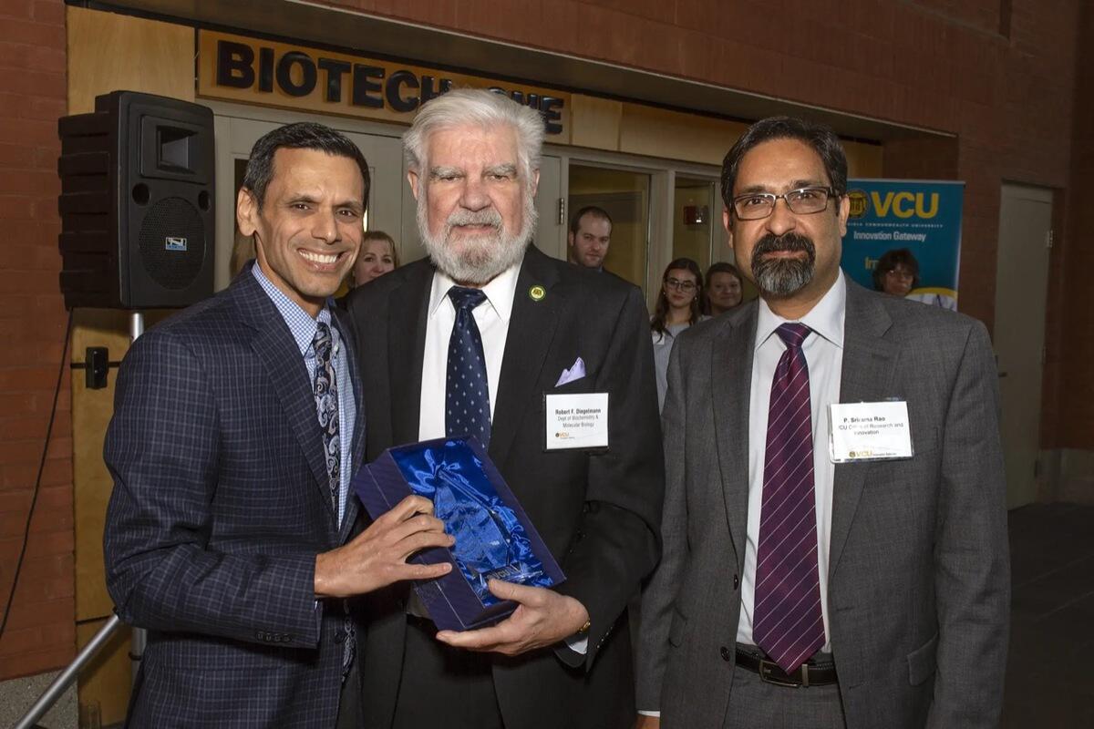 Three men standing next to each other 