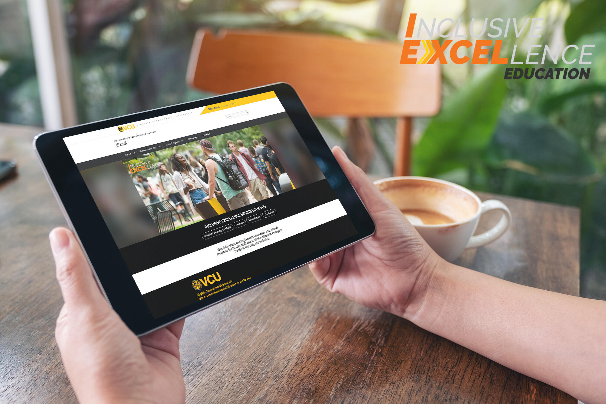 Hands resting on a table while holding an ipad. In the upper left corner is text that reads \"Inclusive Excellence Education\" 