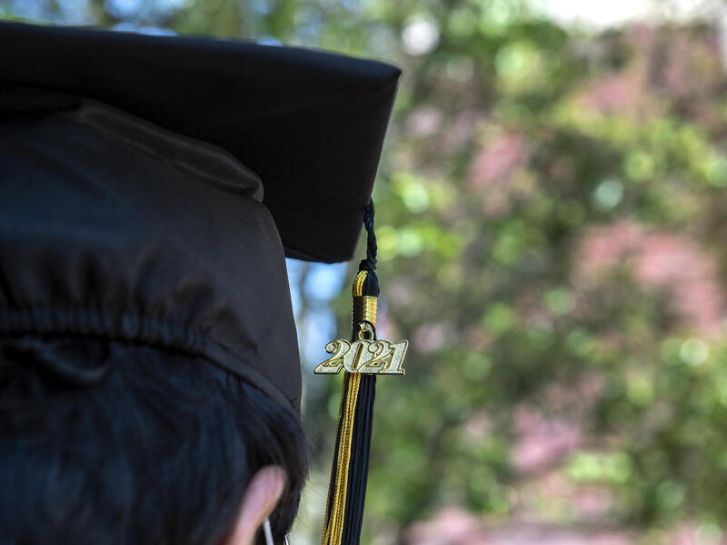 close-up photo of a person wearing a graduation cap