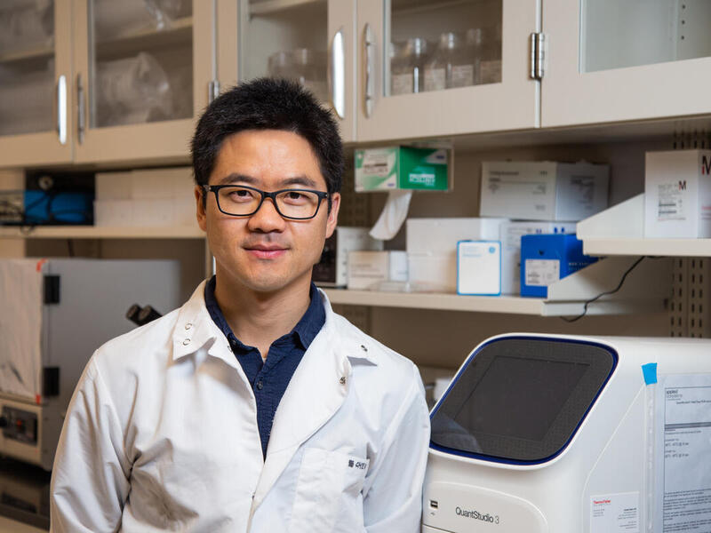 A person sitting in a laboratory.