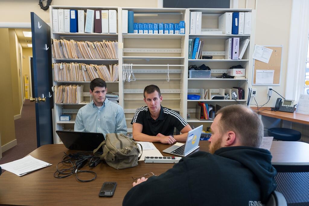 Licensed physical therapist Chris Fosdick (right), a community volunteer, meets with VCU physical therapy students Greg Delano (left) and Matthew Ward (center) to discuss a plan for an upcoming appointment with a patient.