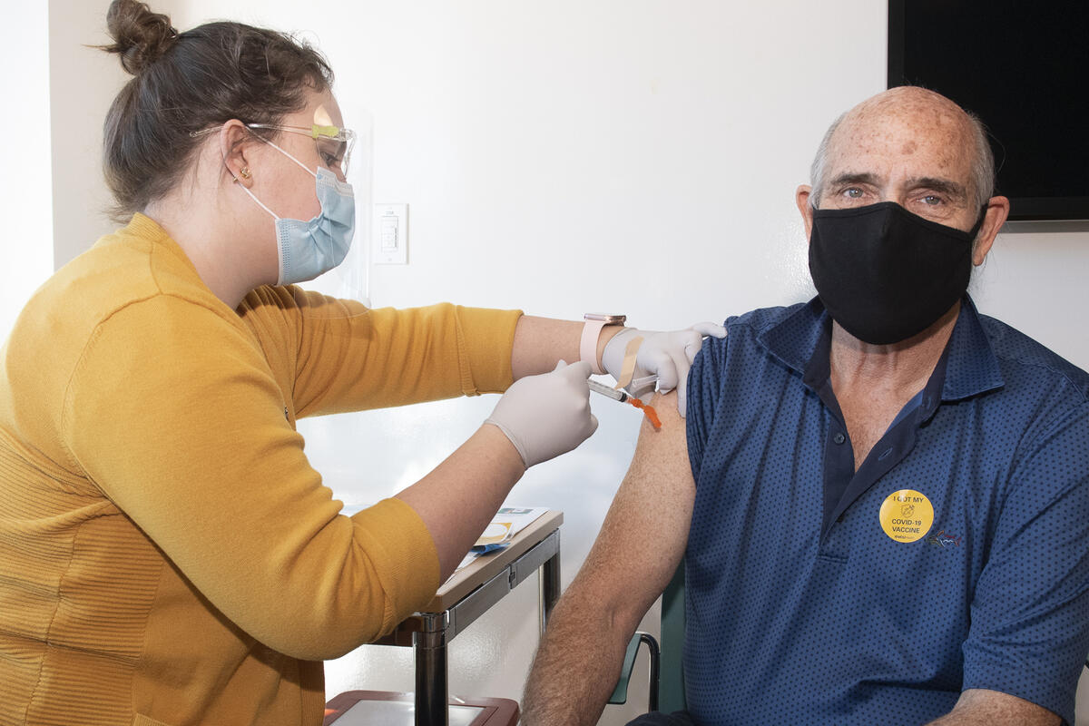 A person receives a vaccine shot.