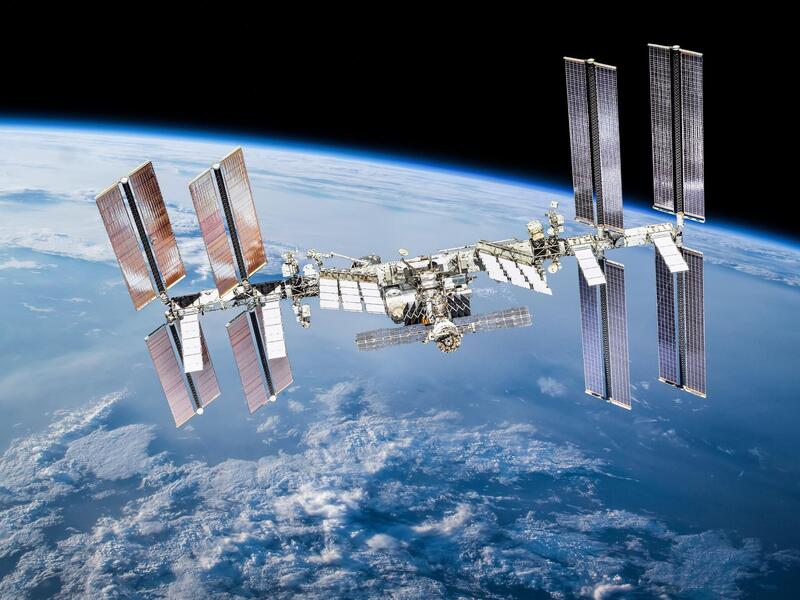 The international space station floating in space over the planet earth.