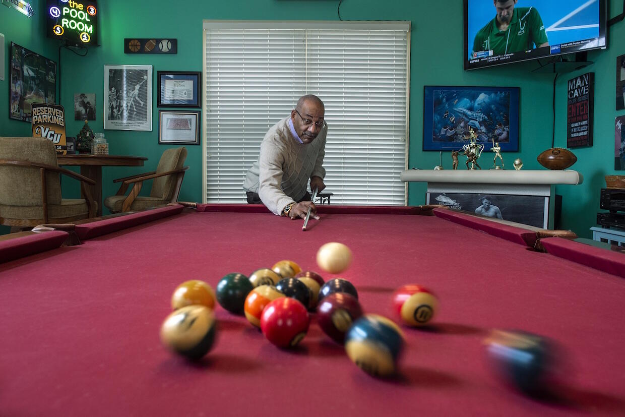 Charles McLeod shooting pool at his house