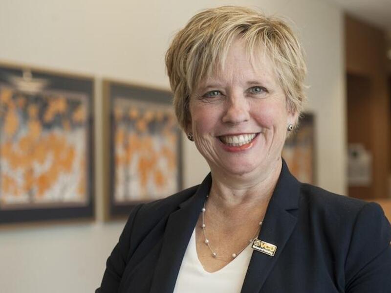 A photo of a woman smiling. 