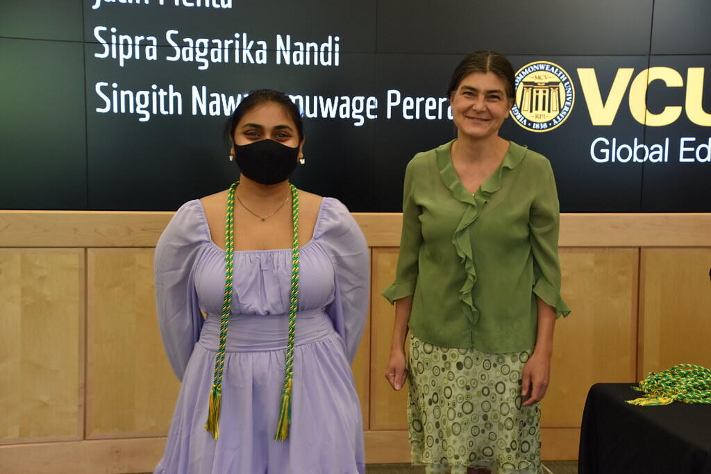 A student standing next to a GLOBE leader