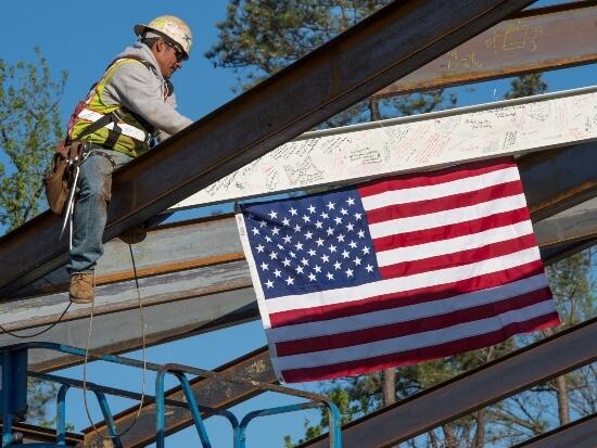 VTCC’s final steel beam is raised into place, topping out the 120,000-square-foot pediatric mental health facility.