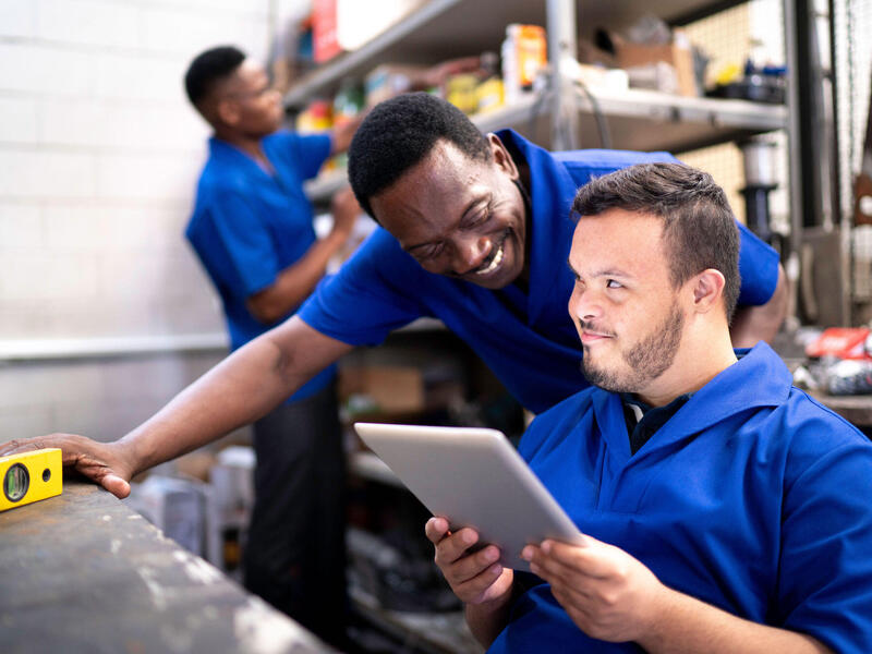 two workers in a back room