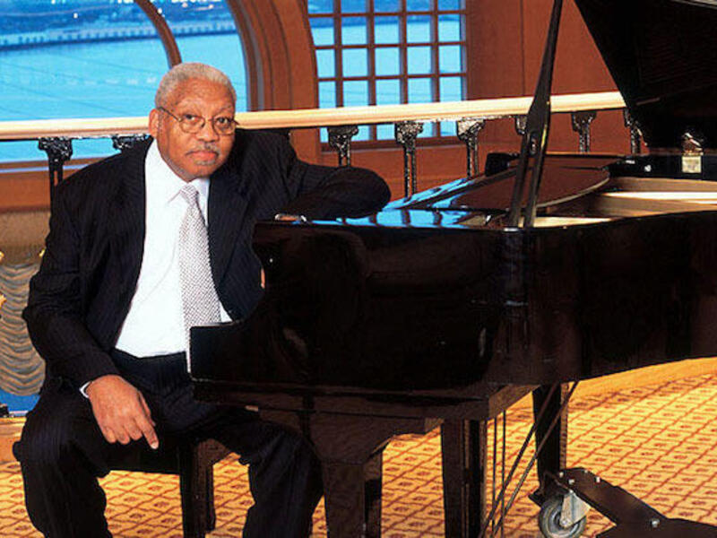 Ellis Marsalis seated at a grand piano.