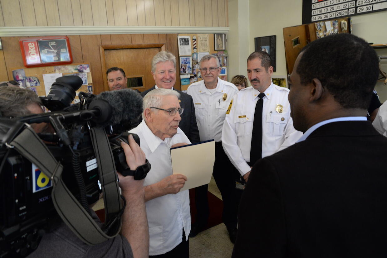 Richmond Mayor Levar Stoney, right, presented Adams with a proclamation recognizing Adams Barber Shop. (Photo credit: Brian McNeill)