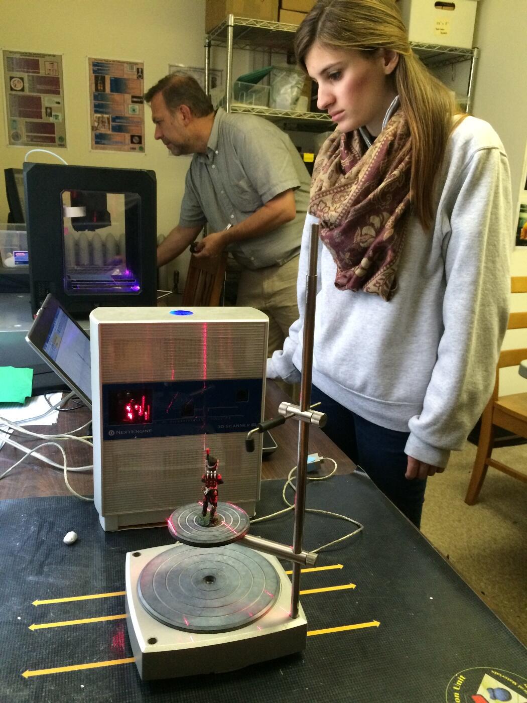 Chelsea Miller, senior history major, 3-D scans a miniature of a French soldier in the Napoleonic Wars, part of the Virginia War Memorial's collection of thousands of military miniatures. 