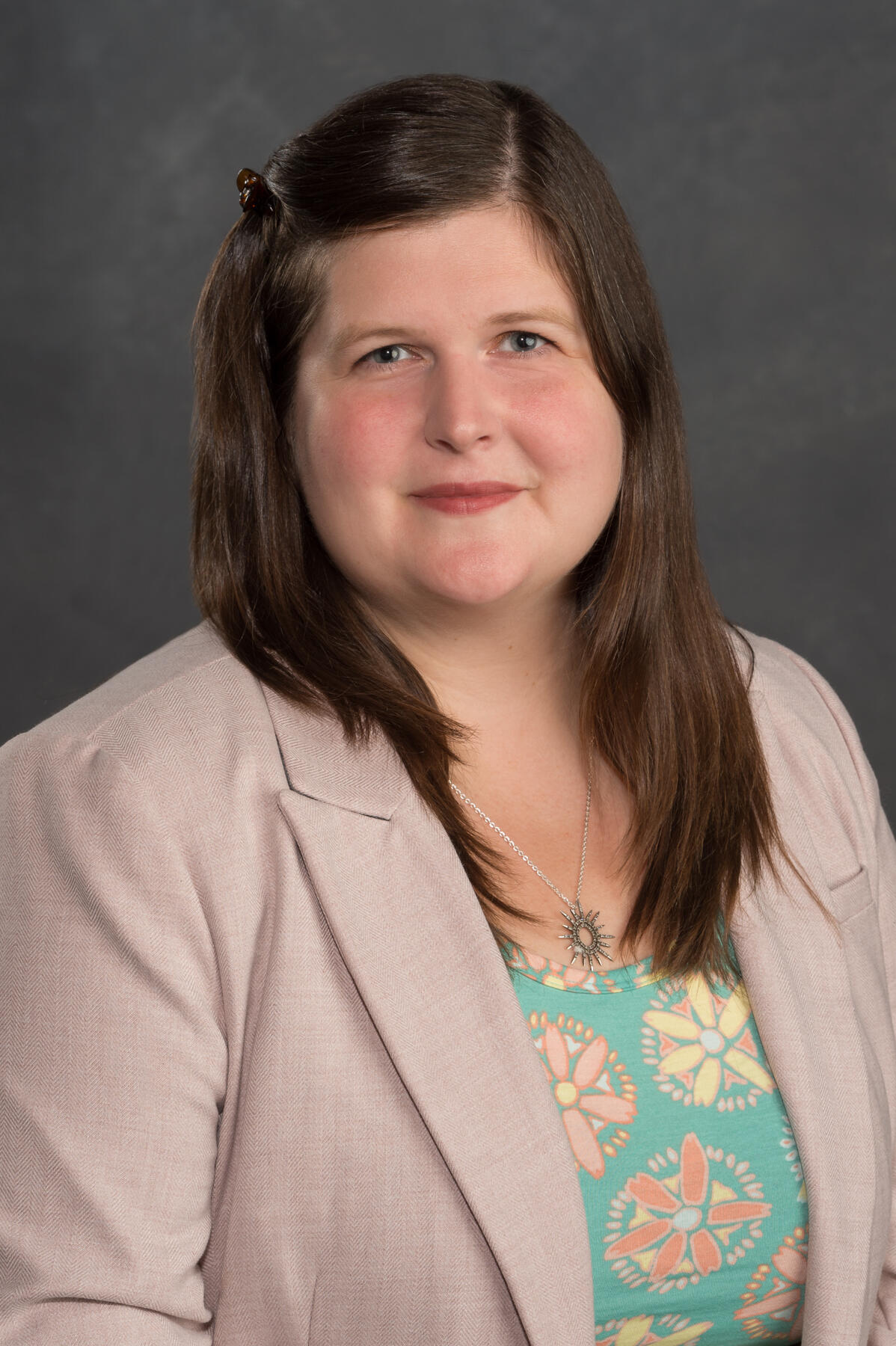 A portait of a woman from the chest up. 