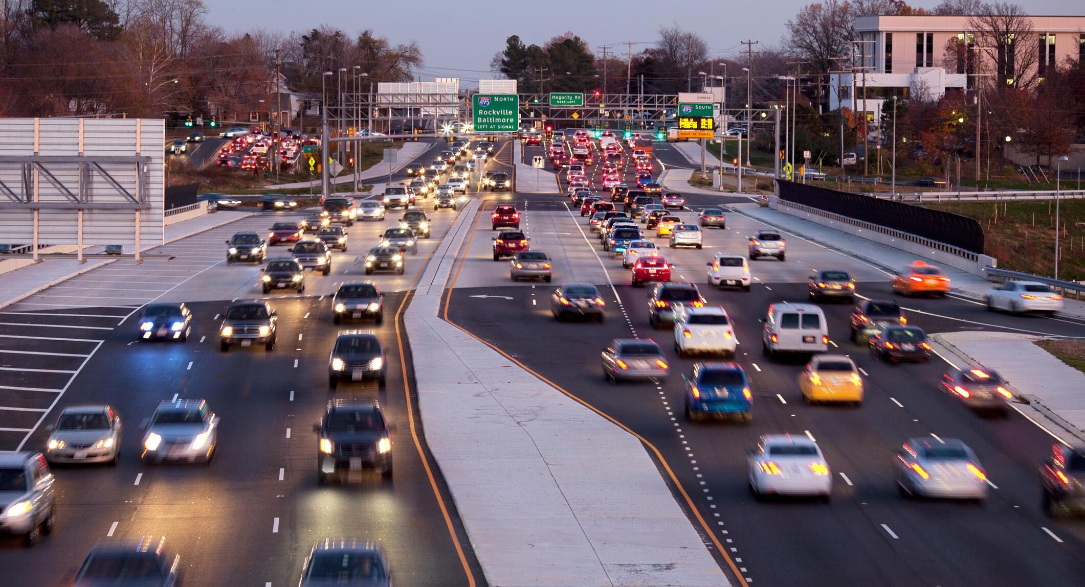 A photo of cars going down a highway. 
