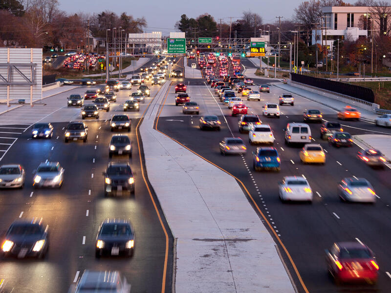 A photo of cars going down a highway. 