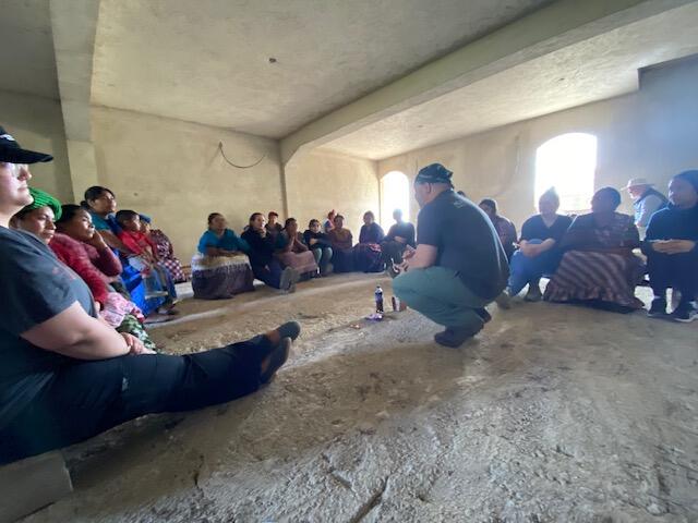A photo of 19 people sitting in a room.