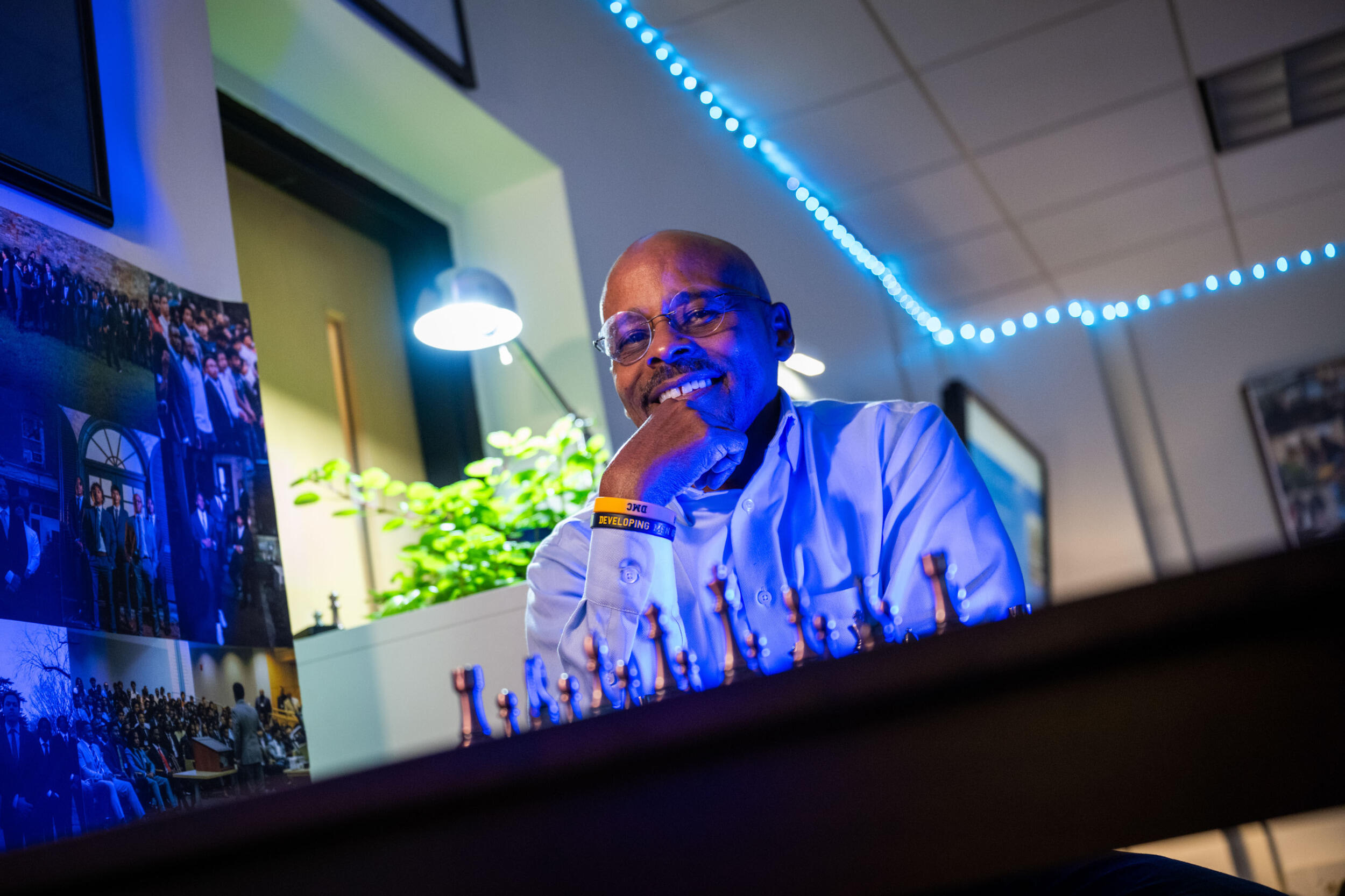 A man sits behind a chess board.