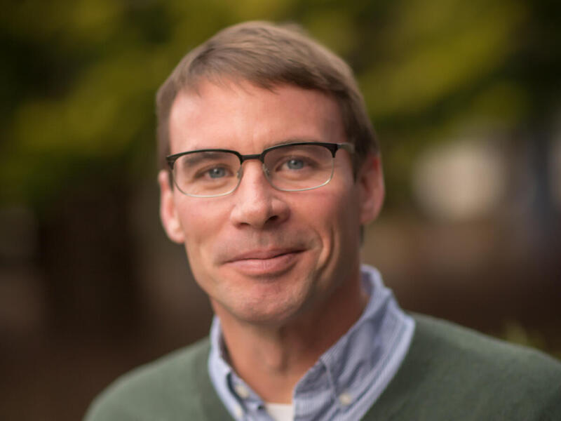 A photo of a man from the chest up. 