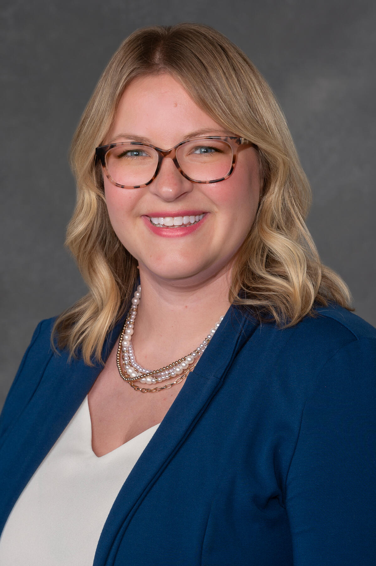 A photo of a woman from the chest up. 