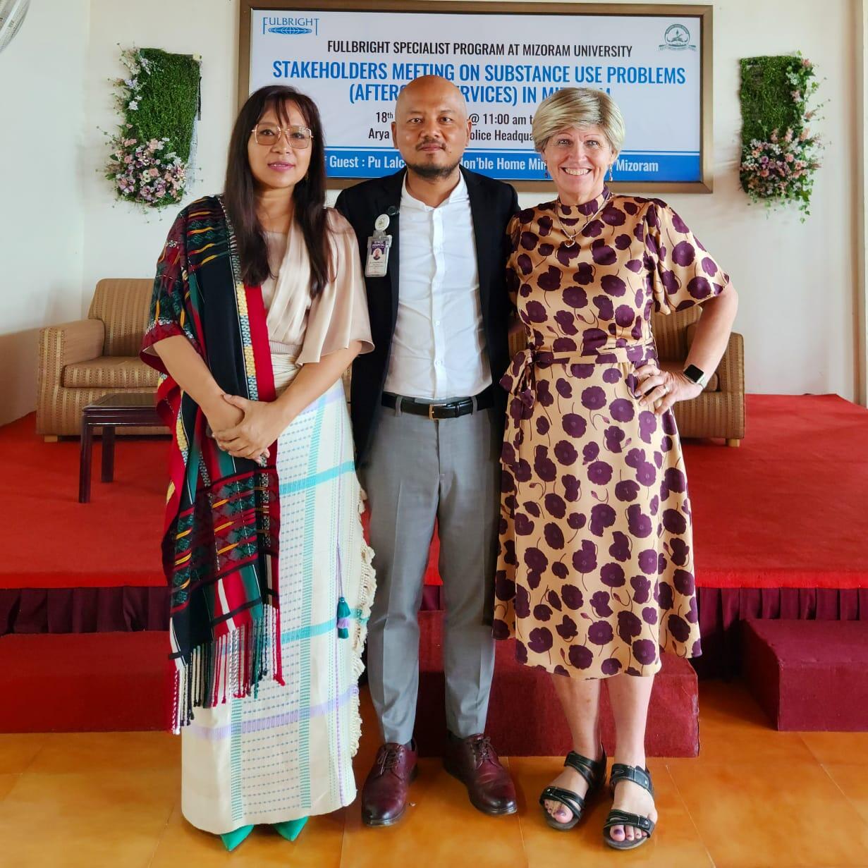 A man standing between two women