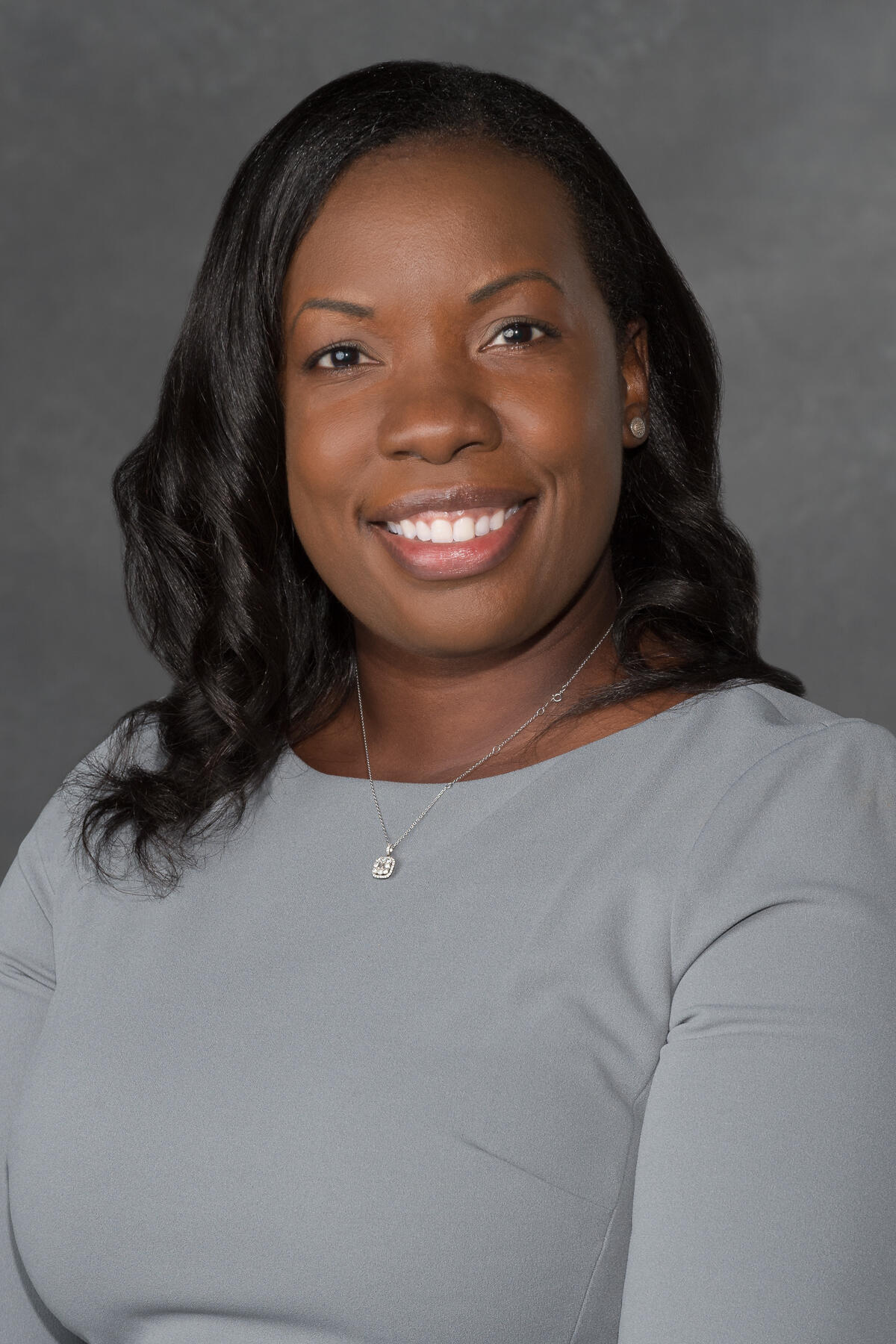 A portait of a woman from the chest up. 