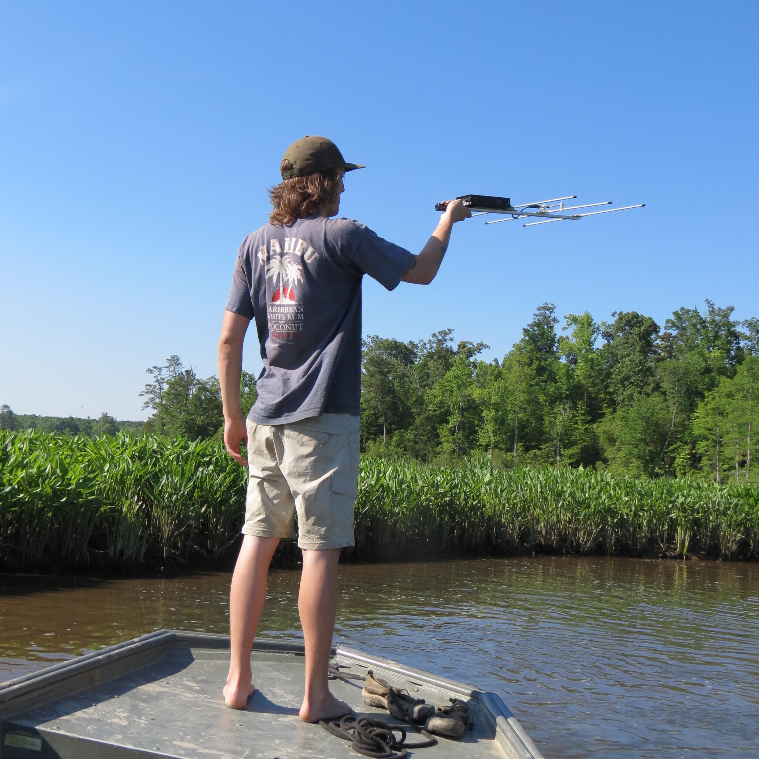 Field technician Eric Burke uses a radio receiver to track snapping turtles. (Photo credit: Courtesy of Team Snapper)