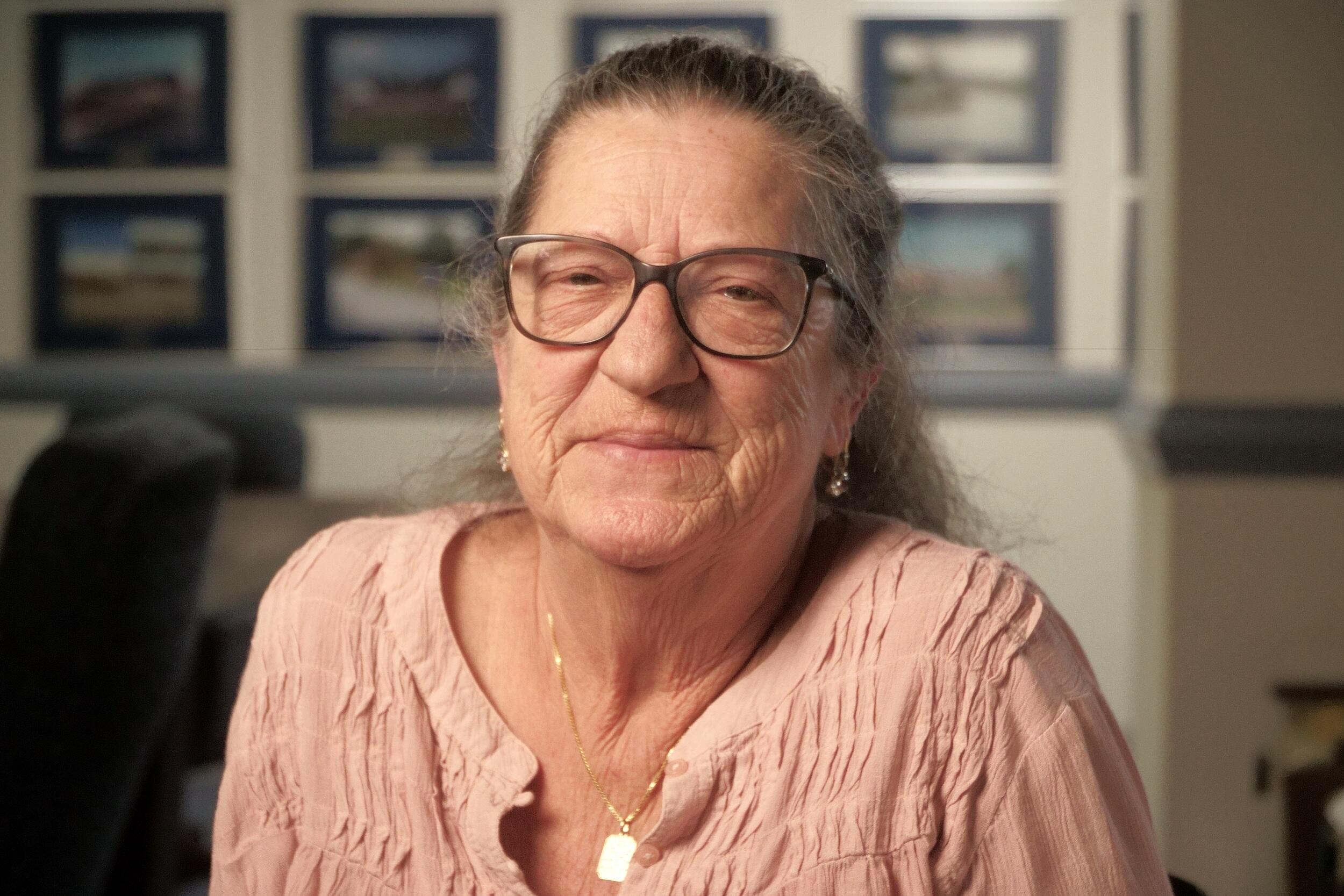 Betty Mattice wearing a pink blouse and glasses 