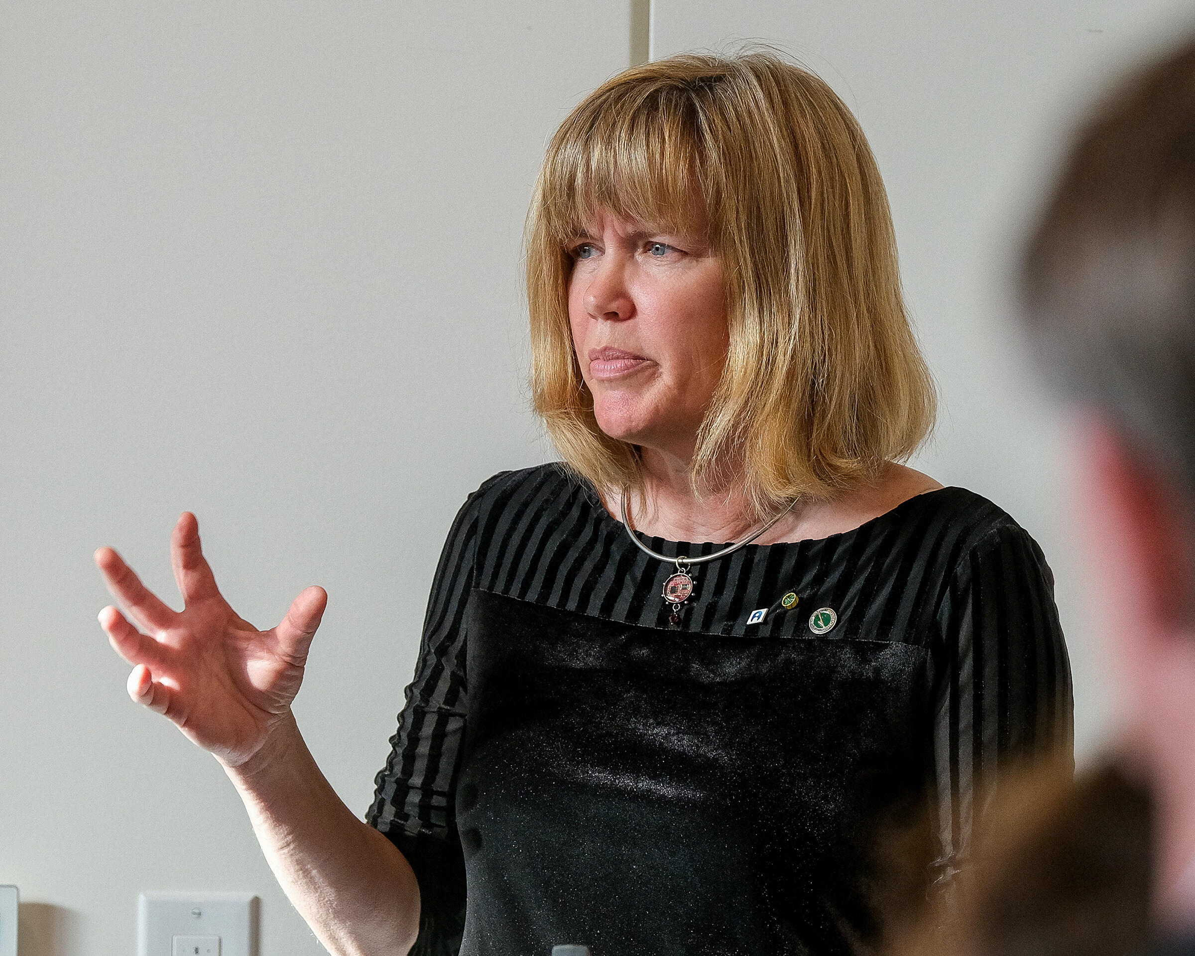 Karen Burg with her hand raised 