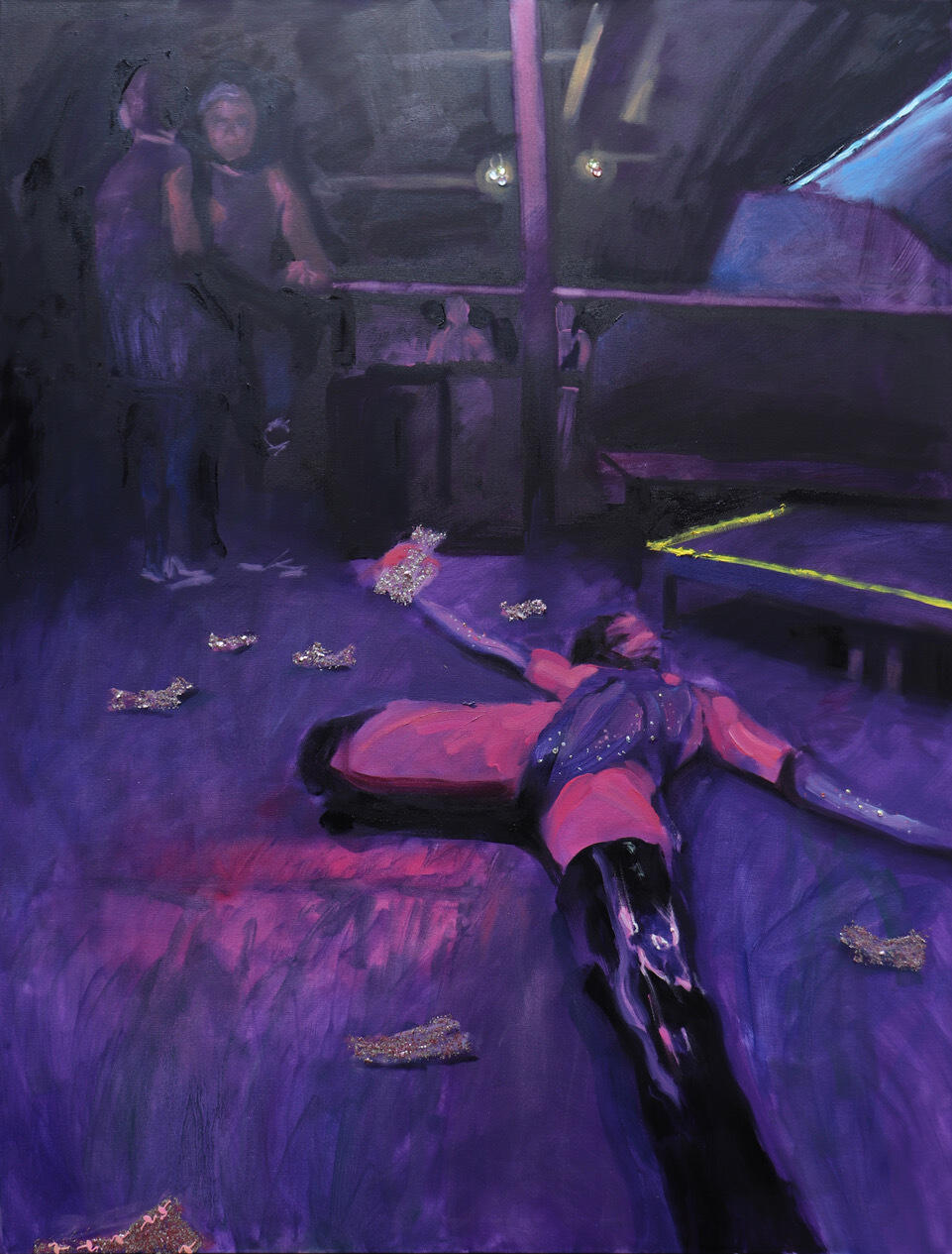 A picture of a drag queen spread on the floor of a club with dollar bills around her. To her left, two people are talking at the side of the stage. 