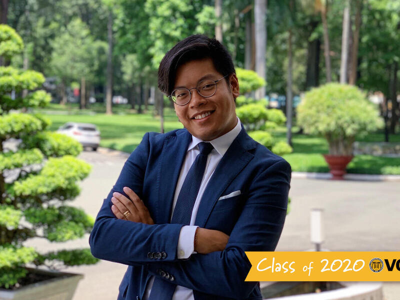 A person in a suit posing for a portrait.