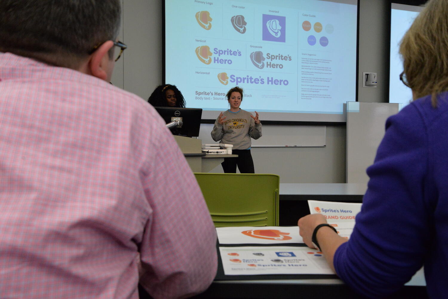 Lauren Berger, a senior in the Department of Communication Arts, presents her team's CreateAthon work to officials with Sprite's HERO. (Photo by Brian McNeill)