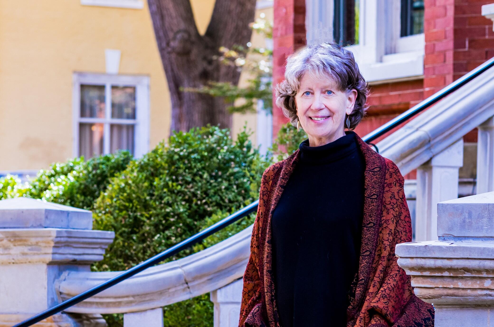 A photo of a woman standing on stairs outside