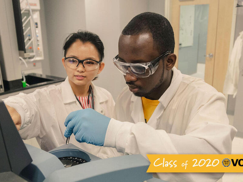 Two people working in a laboratory.