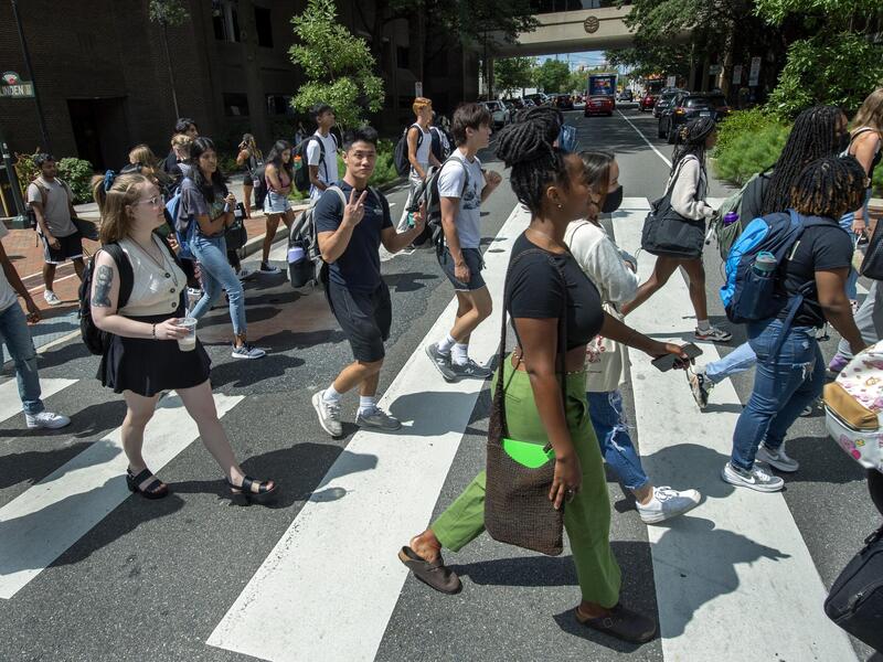 A group of students walking across a crosswalk. 