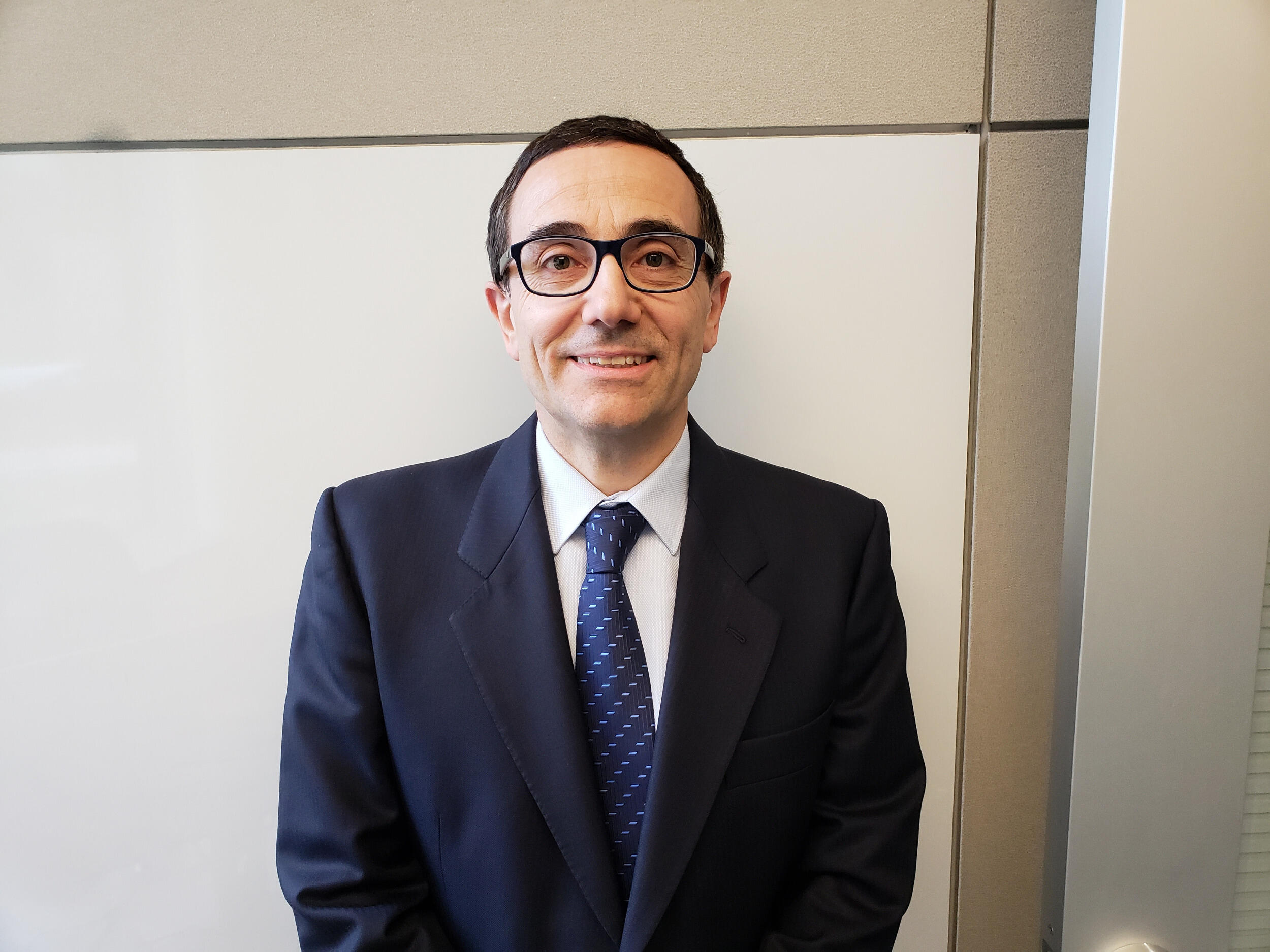 Image of Massimo Bertino smiling in a coat and tie.