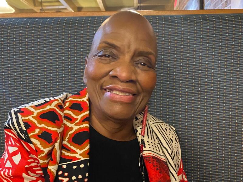 A photo of a woman from the shoulders up. 