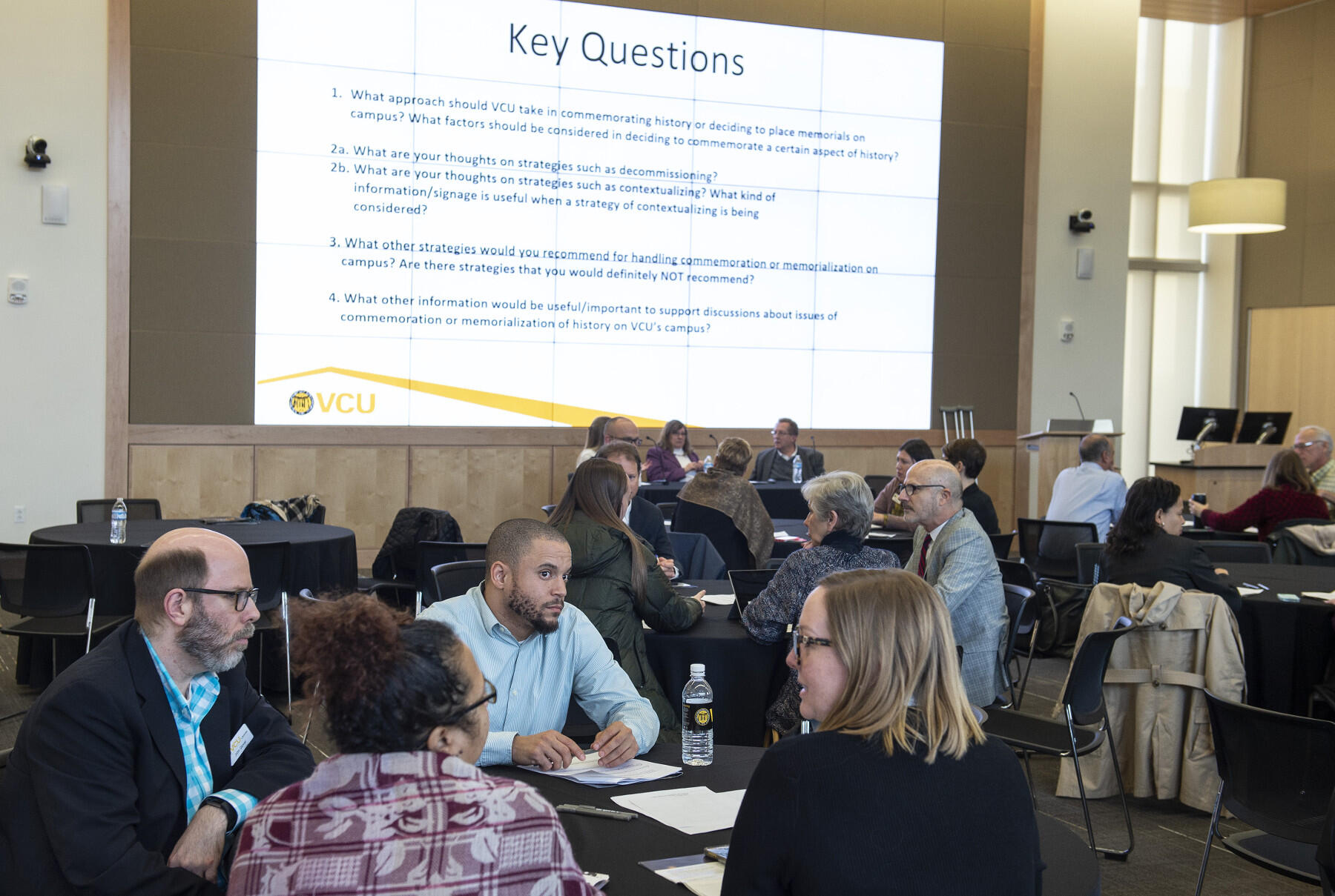 People talk at tables.