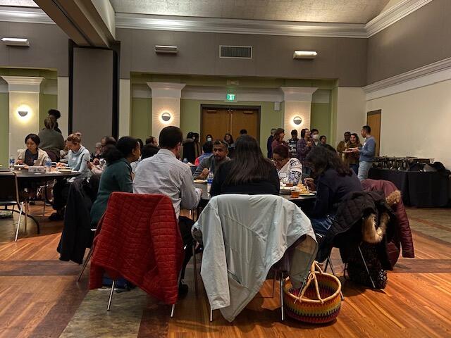 People sitting at tables eating food