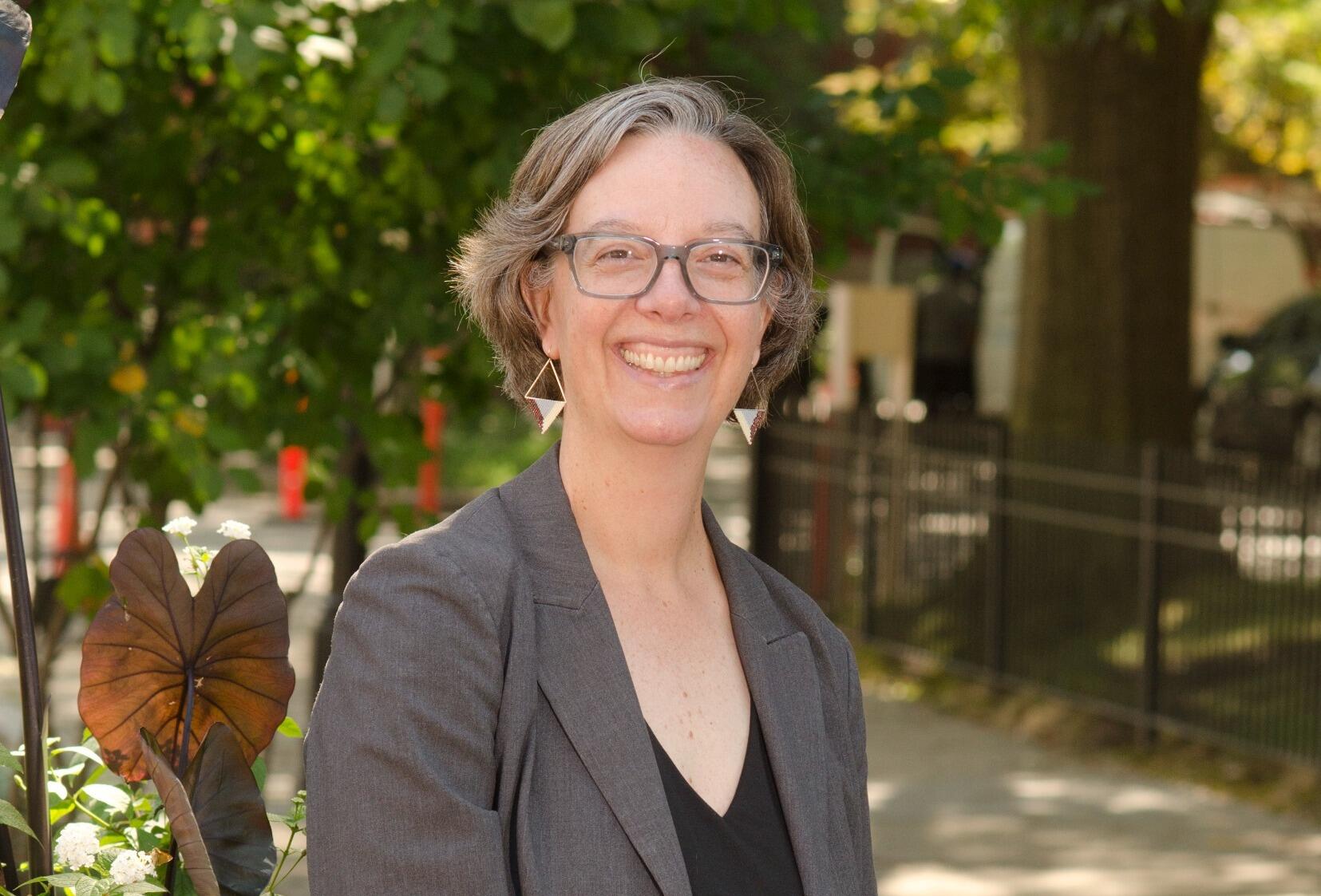 A photo of a woman standing outside. 